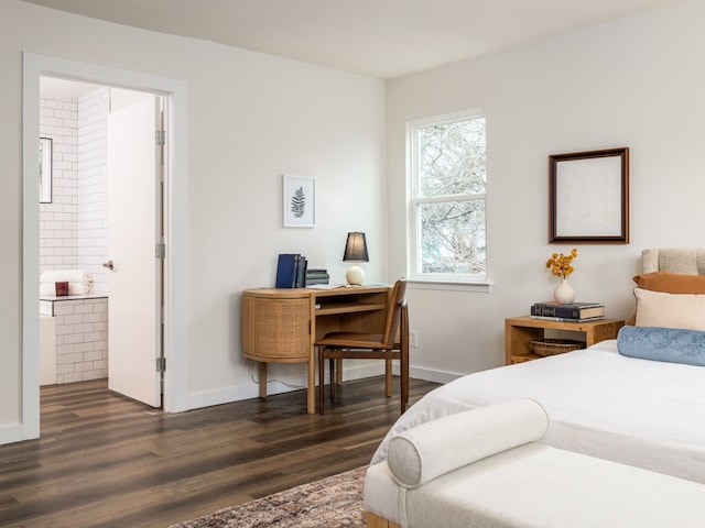 bedroom featuring ensuite bathroom and dark hardwood / wood-style floors