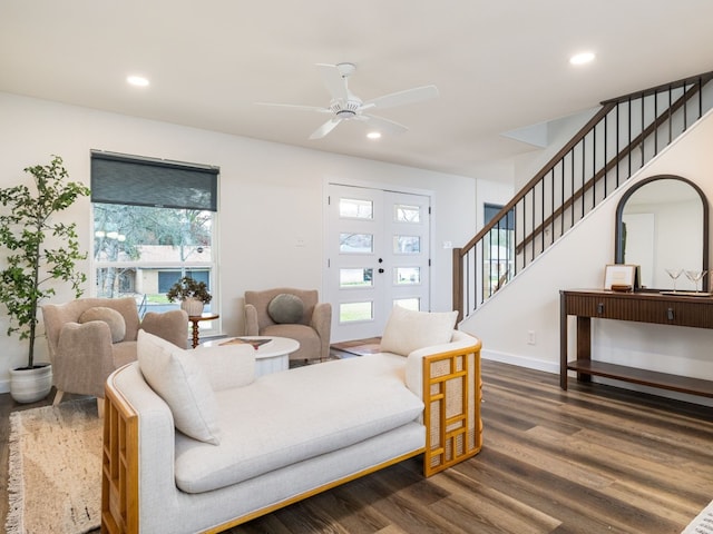 living room with dark wood-type flooring and ceiling fan