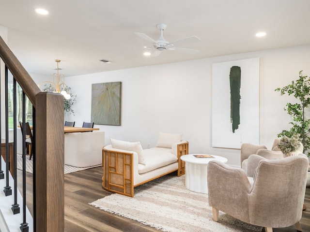 interior space with stairs, ceiling fan with notable chandelier, wood finished floors, and recessed lighting