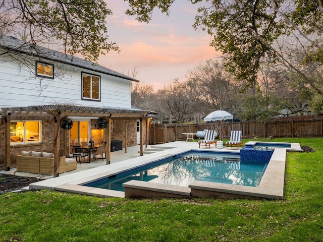 view of pool with a patio, a fenced backyard, outdoor lounge area, a pool with connected hot tub, and a lawn