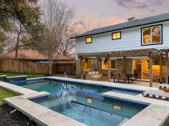 pool at dusk featuring an in ground hot tub, an outdoor hangout area, a patio, and a pergola