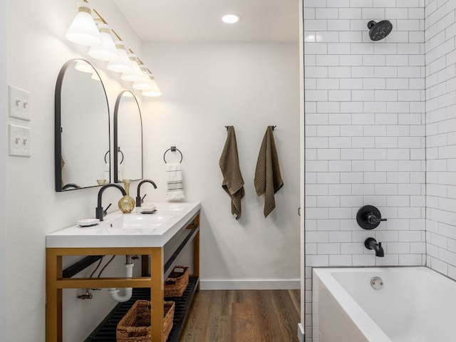 full bath with recessed lighting, bathtub / shower combination, vanity, wood finished floors, and baseboards