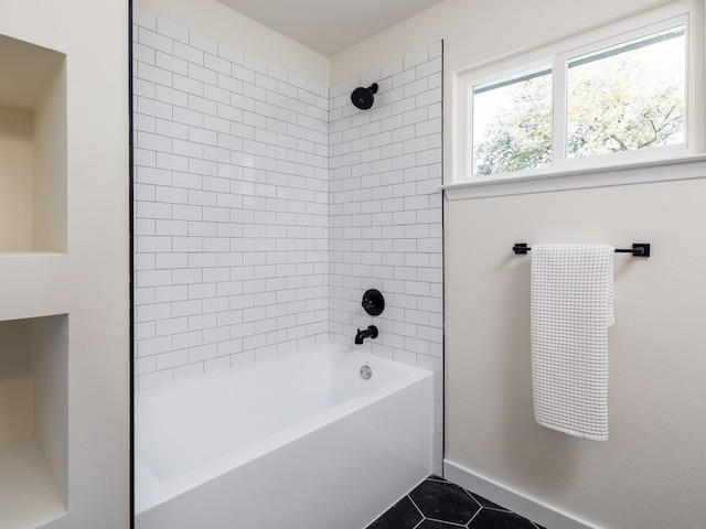 bathroom with tile patterned floors and tiled shower / bath combo