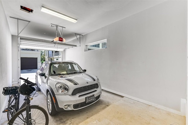 2800 Treble Ln Unit 831, Austin, TX 78704 - garage featuring baseboards and a garage door opener