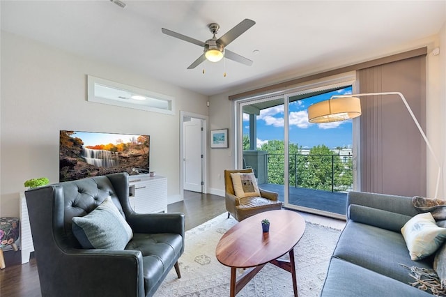 living room with wood-type flooring and ceiling fan