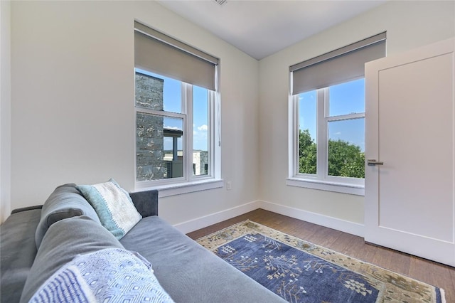 living area with hardwood / wood-style flooring