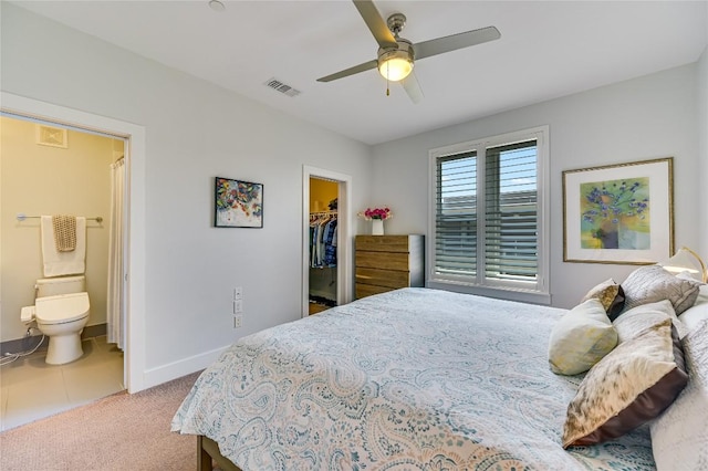 2800 Treble Ln Unit 831, Austin, TX 78704 - carpeted bedroom featuring a walk in closet, a closet, connected bathroom, and a ceiling fan