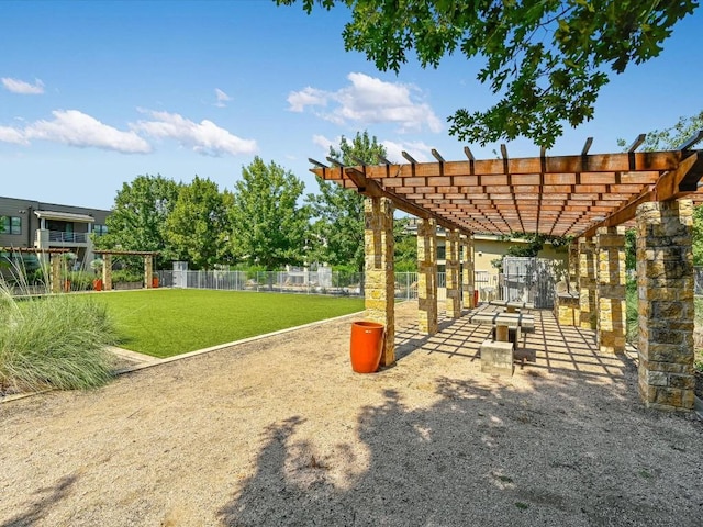 view of community featuring a pergola and a lawn