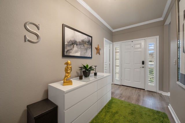 foyer featuring ornamental molding and light hardwood / wood-style floors