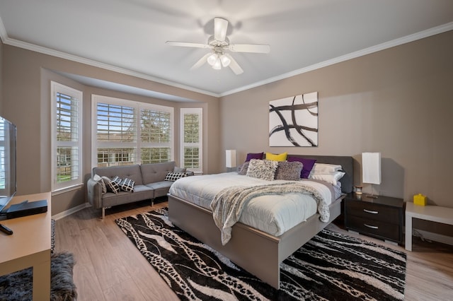 bedroom featuring crown molding, light hardwood / wood-style floors, and ceiling fan