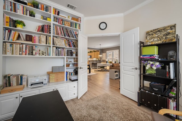 office featuring crown molding and light hardwood / wood-style floors