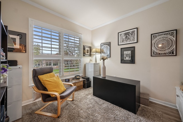 living area with crown molding, independent washer and dryer, and hardwood / wood-style flooring