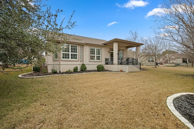 back of property featuring a porch and a lawn