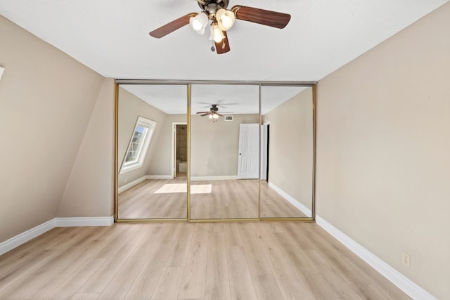 unfurnished bedroom featuring light wood-type flooring, a closet, and ceiling fan