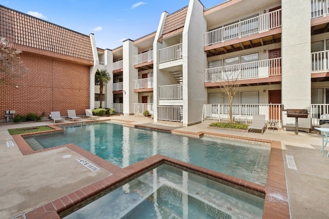 view of pool with a community hot tub