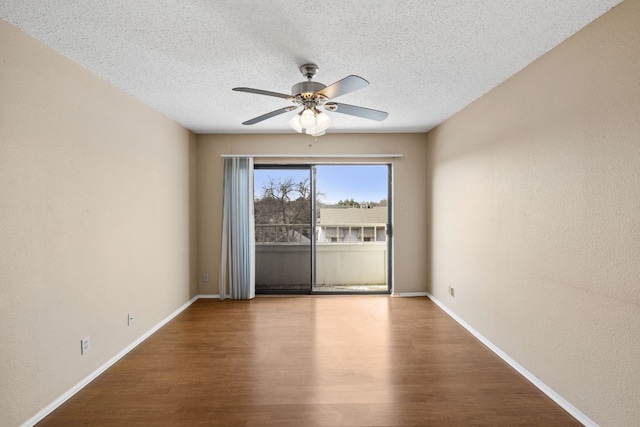 spare room featuring hardwood / wood-style flooring, ceiling fan, and a textured ceiling