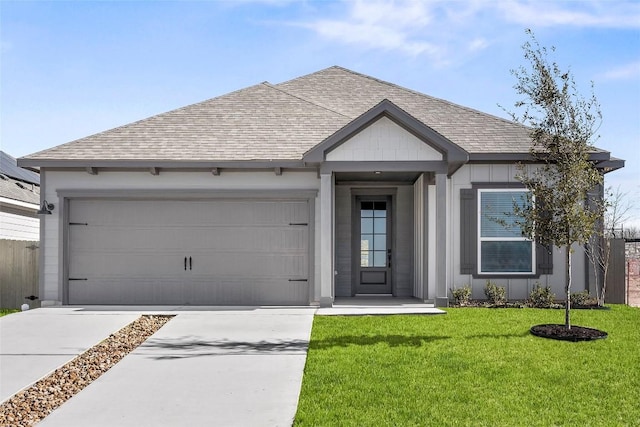 view of front of house with a garage and a front lawn