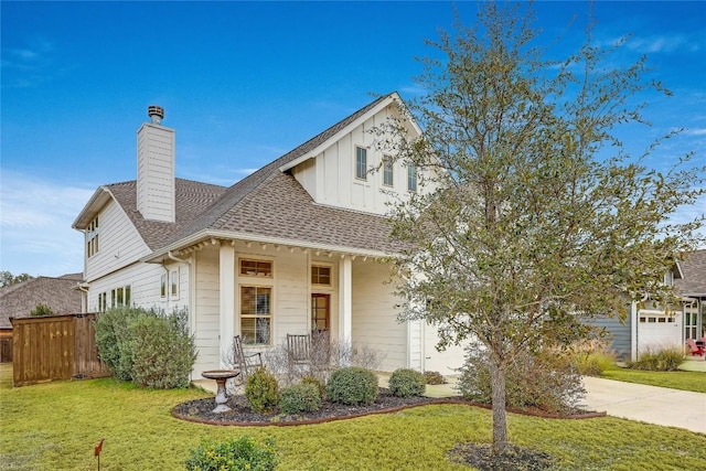 view of front facade featuring a porch, a garage, and a front lawn