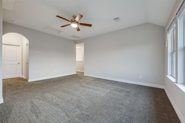 carpeted spare room featuring ceiling fan and vaulted ceiling