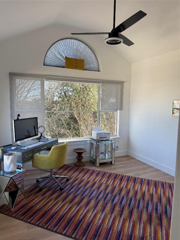 home office with ceiling fan, wood-type flooring, and vaulted ceiling