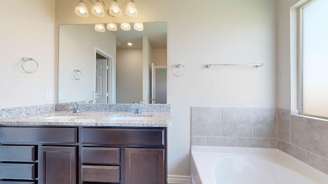 bathroom featuring vanity and a washtub