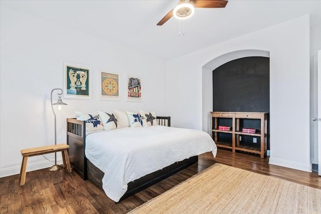 bedroom featuring ceiling fan and dark hardwood / wood-style flooring