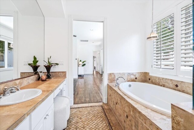 bathroom with vanity, tiled bath, and tile patterned floors