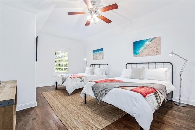 bedroom with ceiling fan and dark hardwood / wood-style flooring