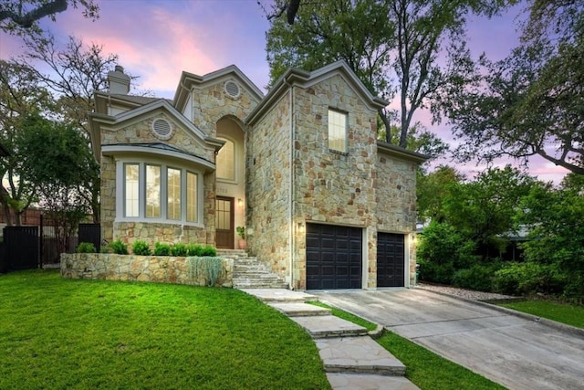 view of front of house featuring a yard and a garage