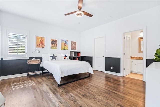 bedroom featuring hardwood / wood-style floors, ceiling fan, and ensuite bathroom