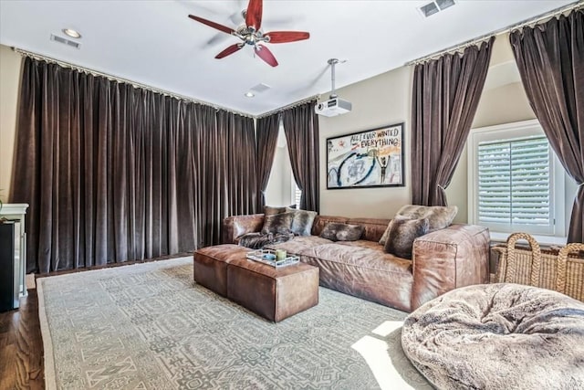 cinema featuring ceiling fan and wood-type flooring