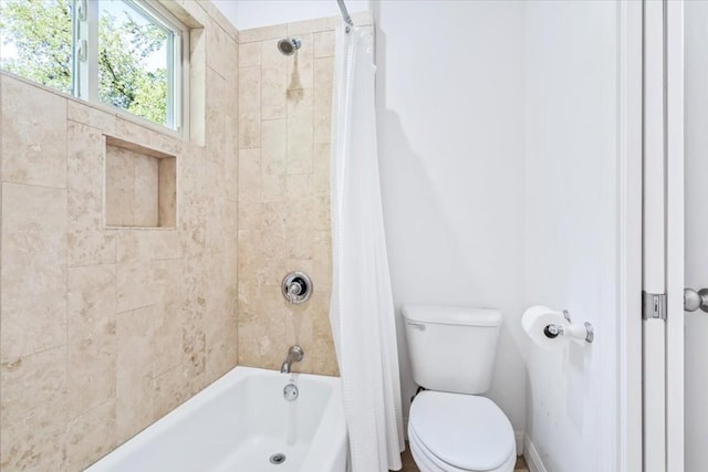 bathroom with toilet and shower / bathtub combination with curtain