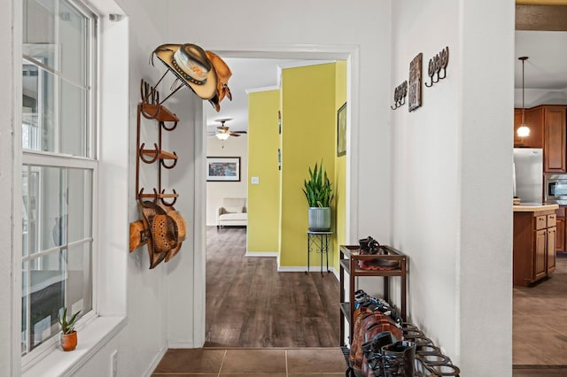 hallway with dark tile patterned flooring