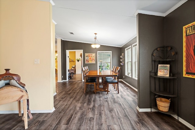 dining room featuring ornamental molding, lofted ceiling, and dark hardwood / wood-style floors