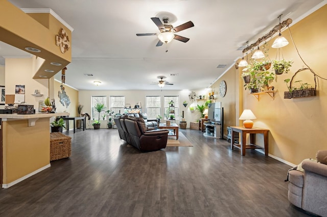 living room featuring ornamental molding, dark wood-type flooring, and ceiling fan