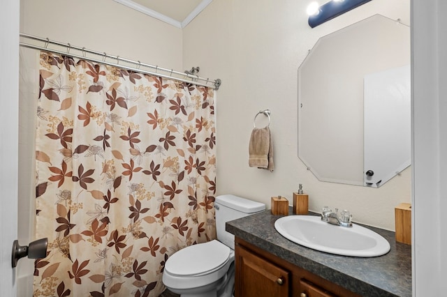 bathroom featuring vanity, crown molding, and toilet