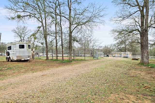 view of yard featuring an outdoor structure and a rural view