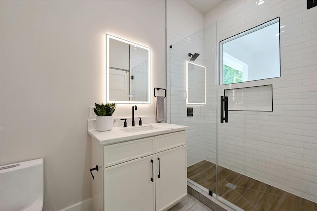 bathroom with vanity, toilet, and walk in shower