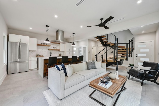 living room featuring ceiling fan and sink