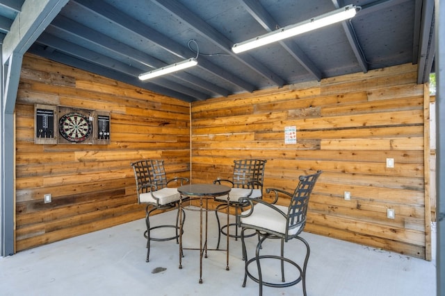 interior space with lofted ceiling and wood walls