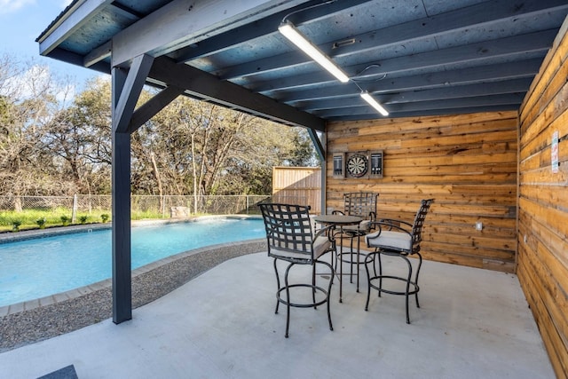 view of patio / terrace with a fenced in pool