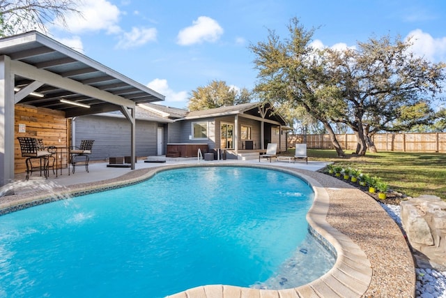 view of pool with a hot tub, an outdoor structure, pool water feature, and a patio area