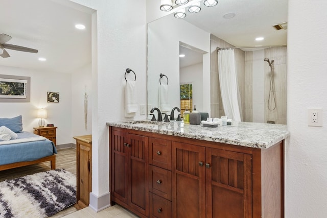 bathroom featuring ceiling fan, vanity, and curtained shower