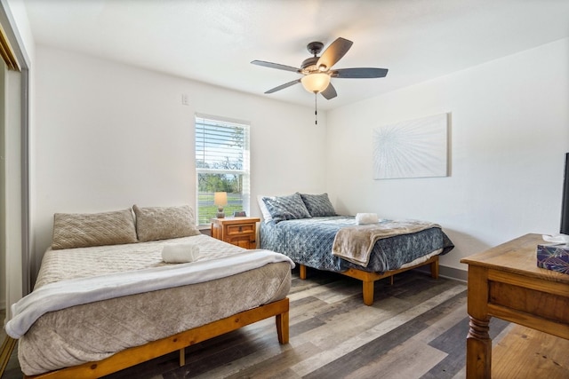 bedroom with hardwood / wood-style flooring and ceiling fan