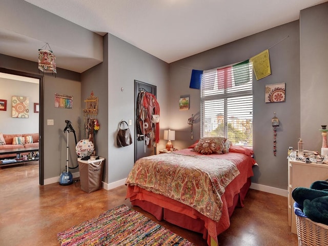 bedroom featuring concrete flooring