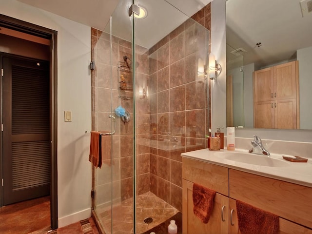 bathroom with walk in shower and vanity