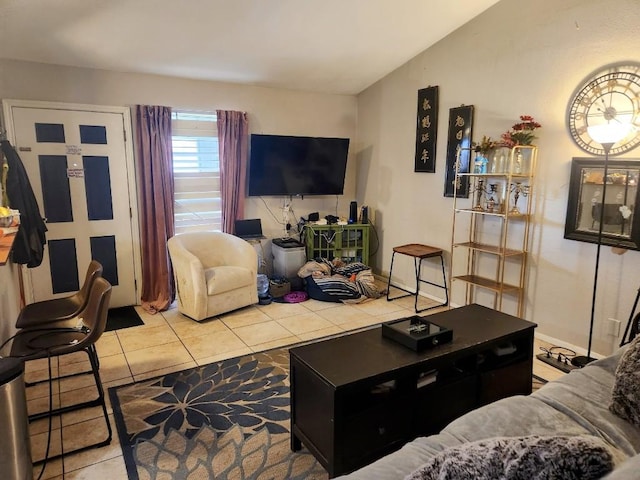 living room featuring vaulted ceiling and light tile patterned floors