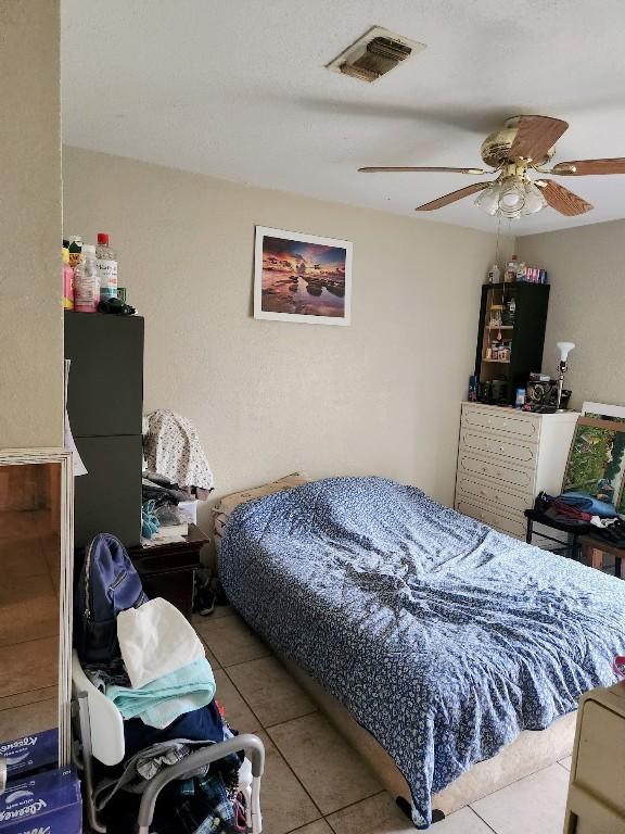 bedroom featuring light tile patterned floors and ceiling fan