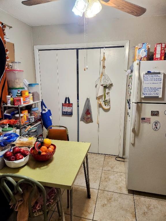 kitchen featuring white fridge and light tile patterned floors