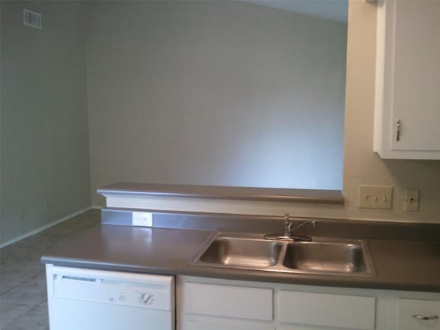 kitchen with white dishwasher, sink, and white cabinets